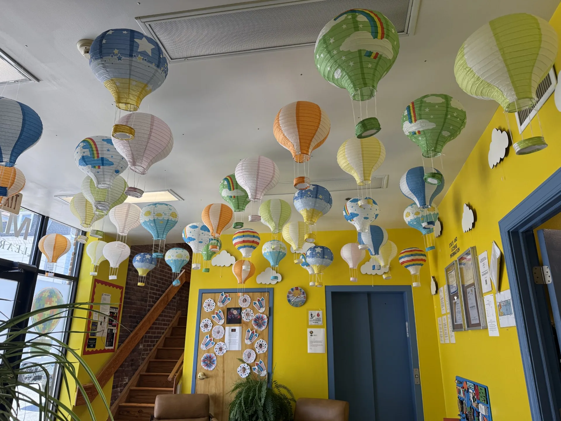 Lobby ceiling decorated with dozens of hot air balloon lanterns