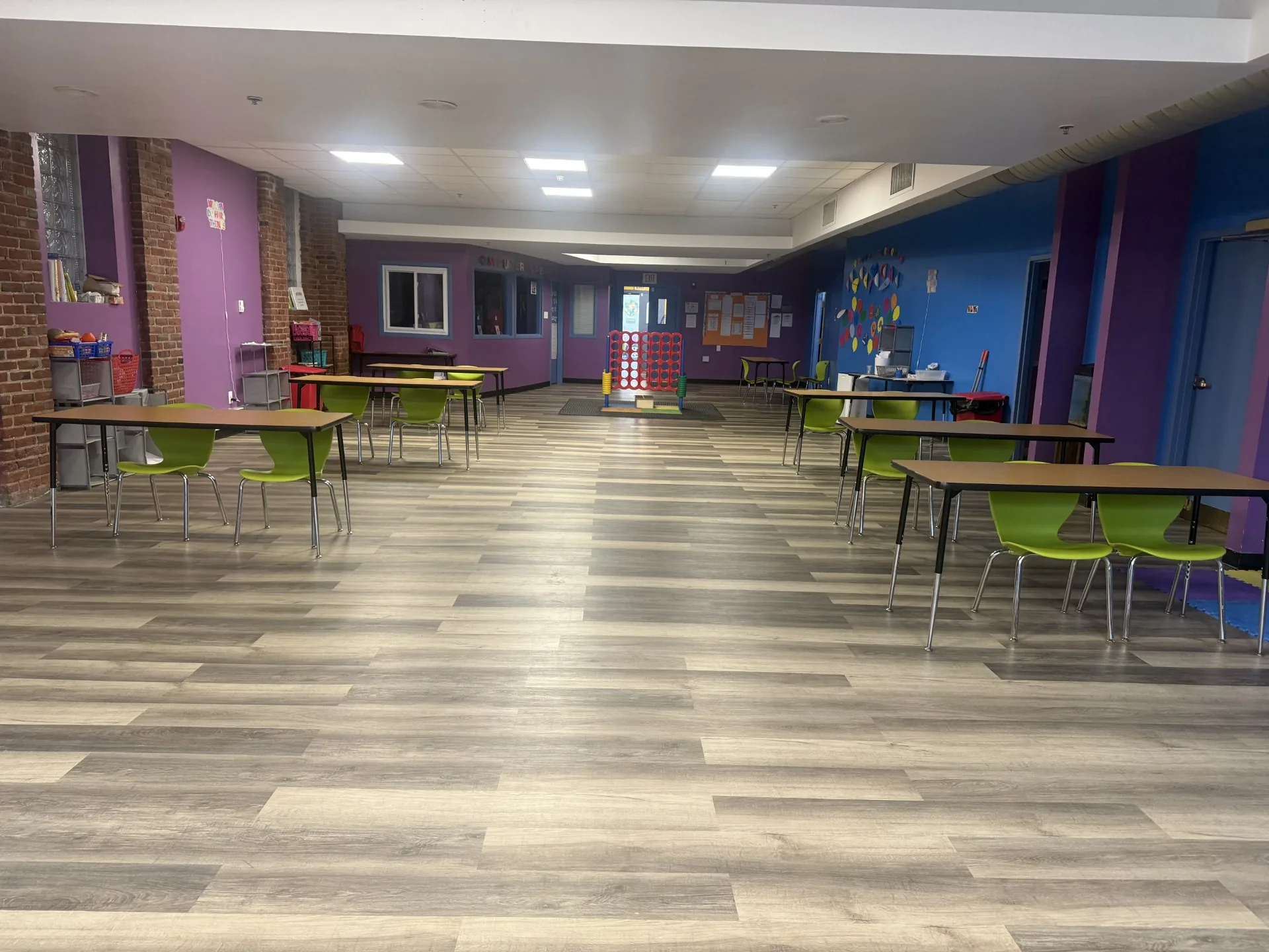 Spacious school-age classroom with tables and chairs