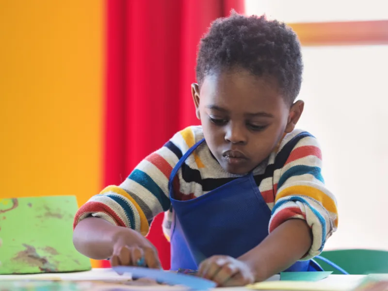 Preschooler drawing at a table