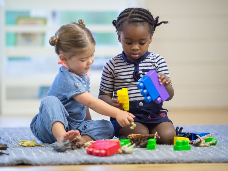 Toddler stacking colorful blocks