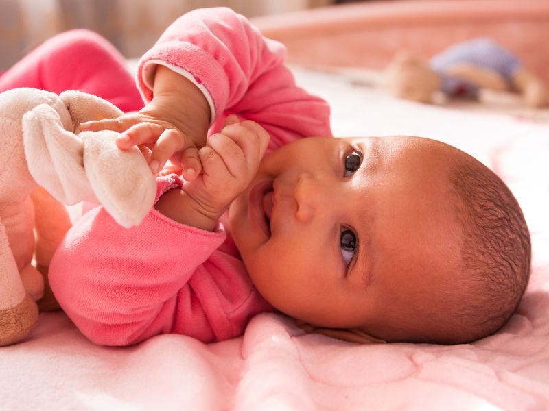Happy infant with plush toy