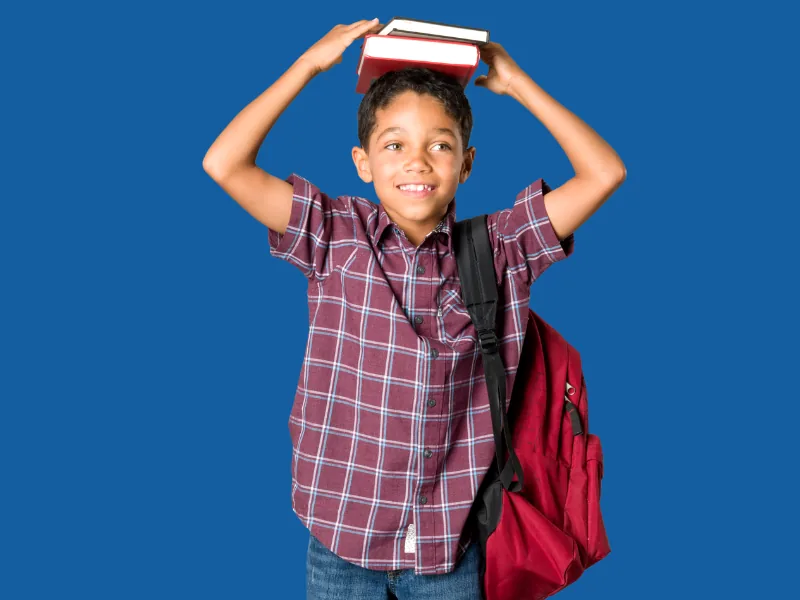 School-age child with a backpack in a classroom